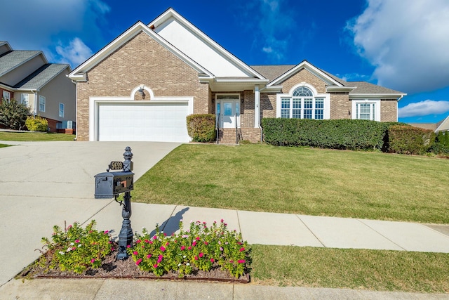 view of front of house featuring a garage and a front lawn