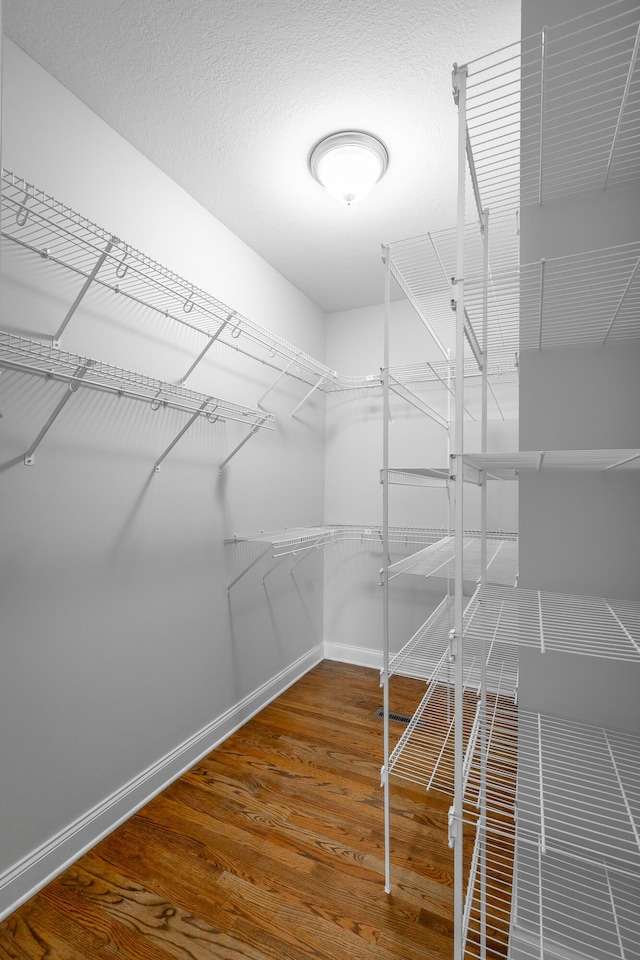 walk in closet featuring hardwood / wood-style floors