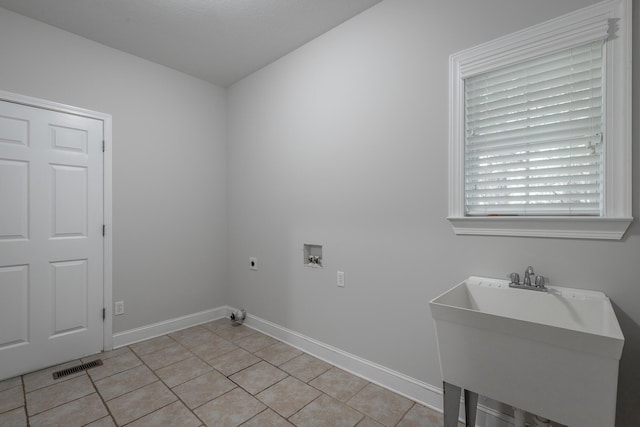 laundry area featuring electric dryer hookup, sink, light tile patterned flooring, and washer hookup