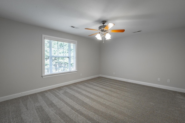 carpeted spare room with ceiling fan