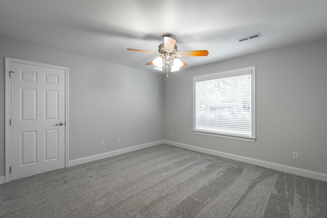 carpeted empty room featuring ceiling fan