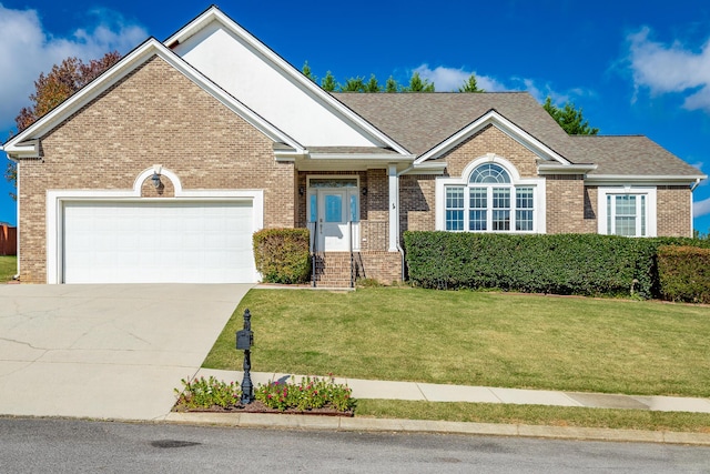 view of front facade with a front yard and a garage