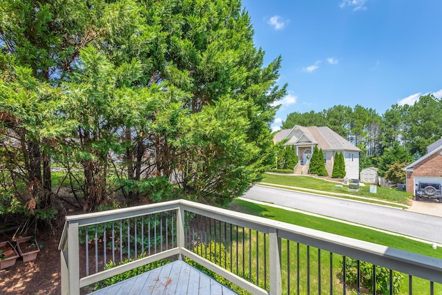 wooden deck featuring a yard