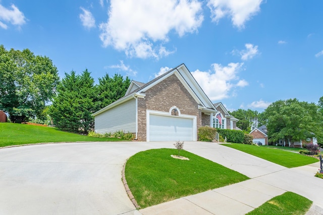 view of front of house with a garage and a front lawn