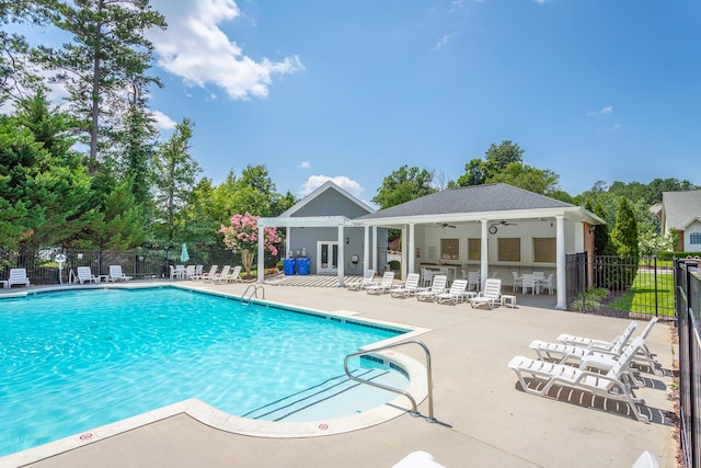 view of swimming pool featuring a patio area and ceiling fan