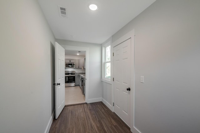 corridor featuring dark hardwood / wood-style flooring