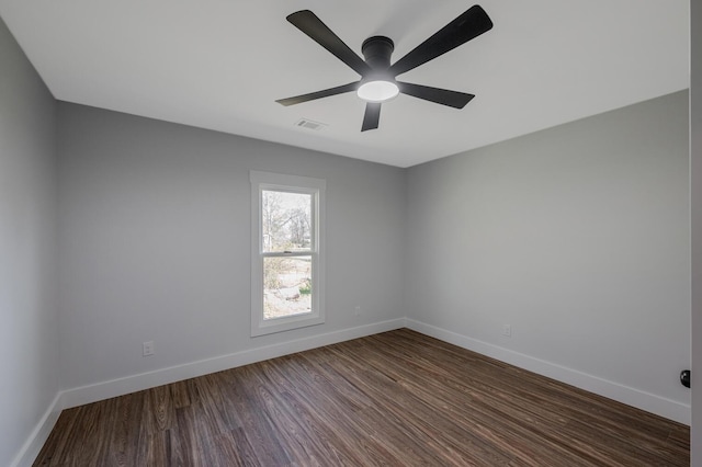 unfurnished room featuring ceiling fan and dark wood-type flooring