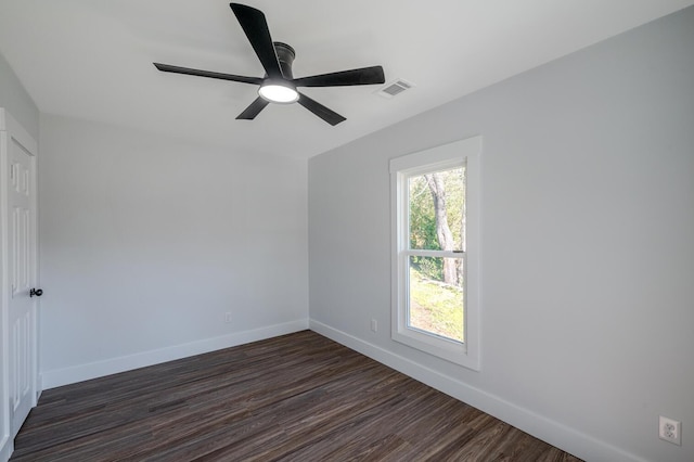 empty room with ceiling fan and dark wood-type flooring