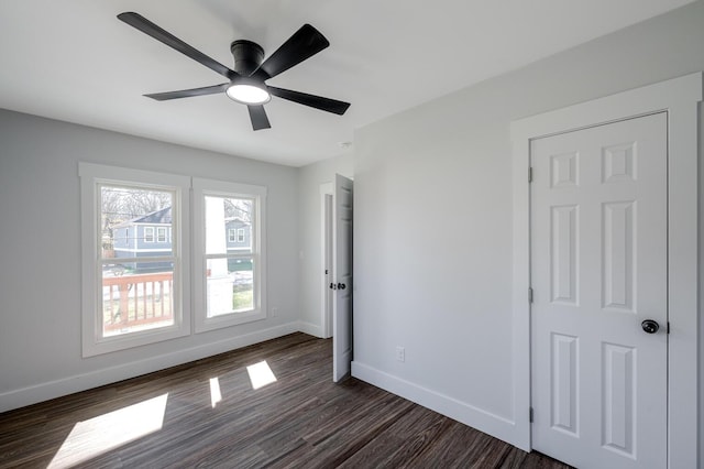 spare room with ceiling fan and dark hardwood / wood-style flooring