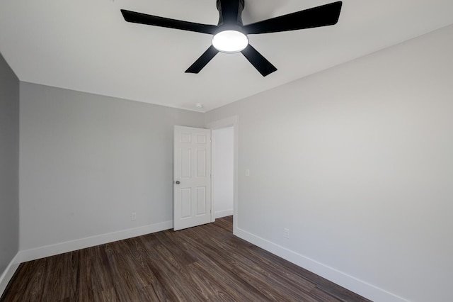 empty room featuring ceiling fan and dark wood-type flooring