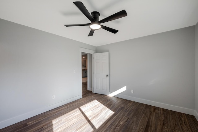 unfurnished room featuring ceiling fan and dark wood-type flooring