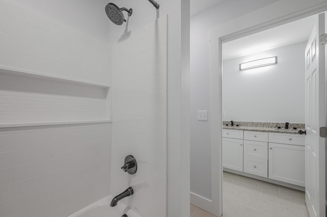 bathroom with tile patterned flooring, vanity, and tiled shower / bath combo