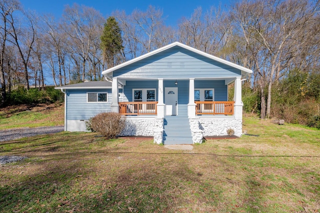 view of front of house with a porch and a front lawn