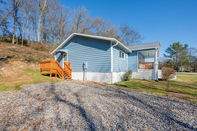 view of side of home with covered porch