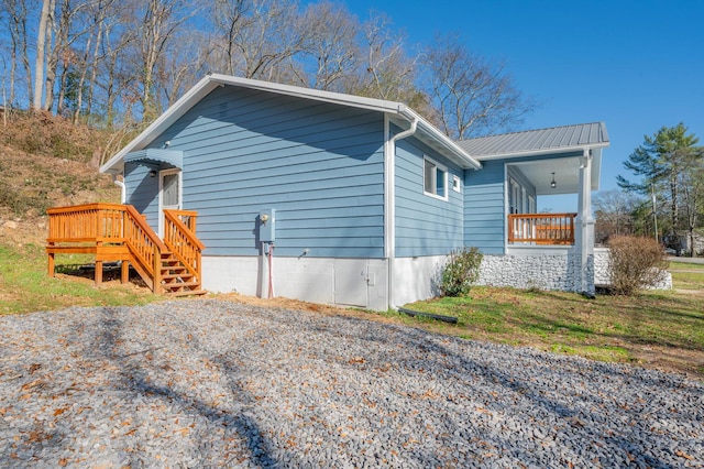 view of side of property with covered porch