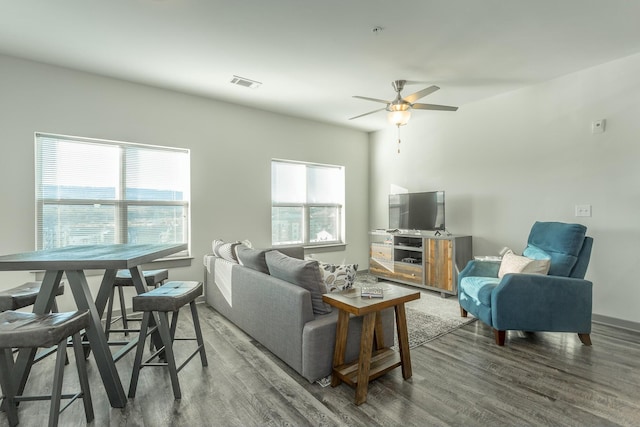 living room featuring ceiling fan and dark hardwood / wood-style floors