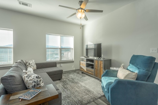 living room featuring wood-type flooring and ceiling fan