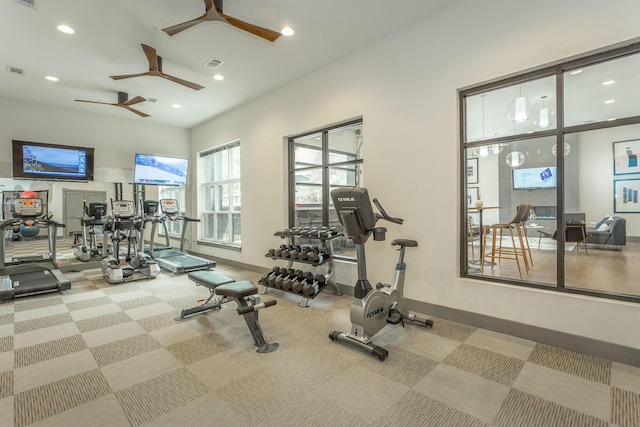 workout area featuring carpet flooring and ceiling fan