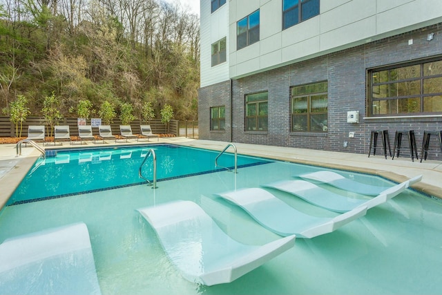 view of swimming pool with a patio area