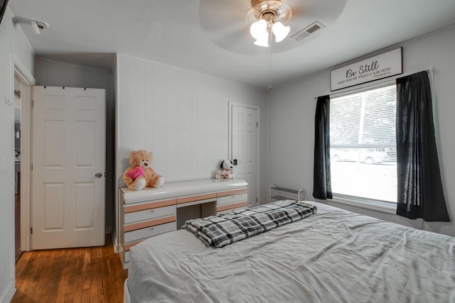 bedroom with ceiling fan and dark wood-type flooring