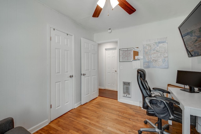 office area featuring heating unit, light hardwood / wood-style floors, and ceiling fan