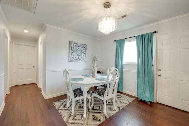 dining area with dark hardwood / wood-style flooring, crown molding, and a notable chandelier