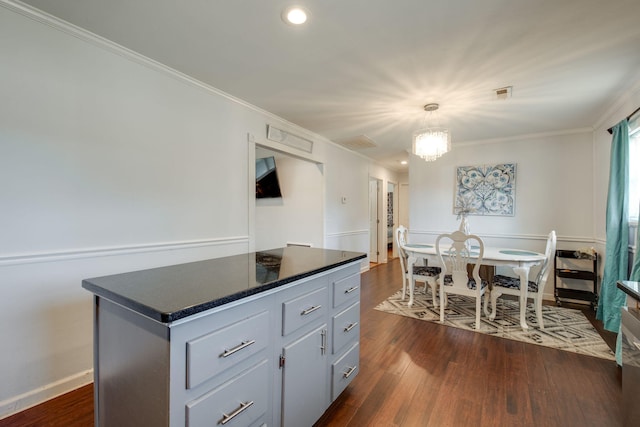 kitchen featuring a chandelier, a center island, dark hardwood / wood-style floors, and ornamental molding