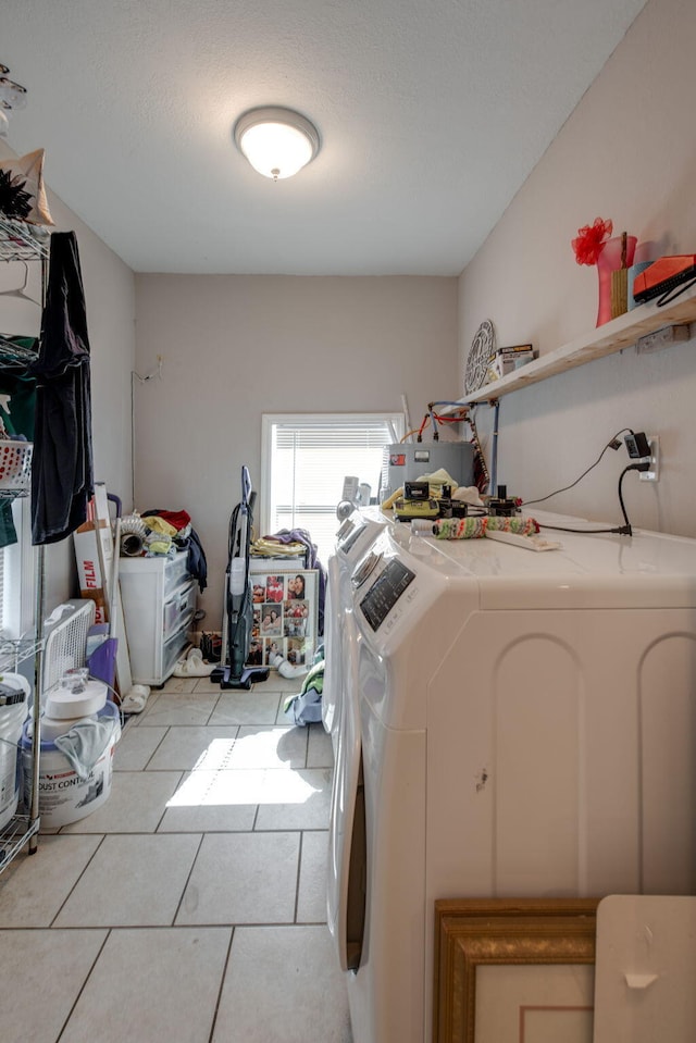 laundry room with independent washer and dryer and light tile patterned floors