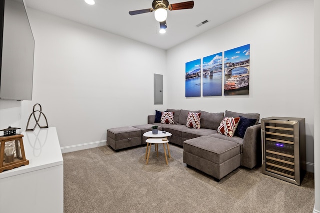 carpeted living room with electric panel, wine cooler, and ceiling fan