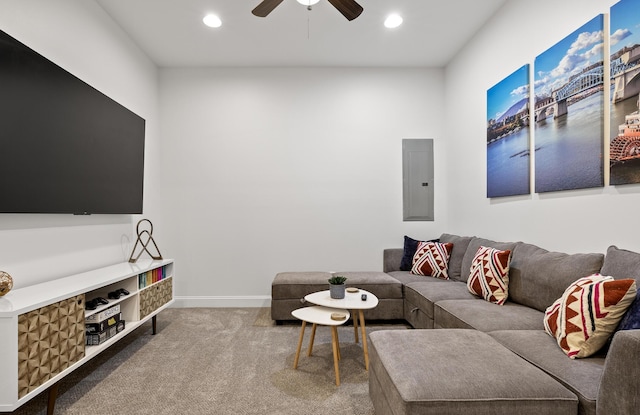 carpeted living room with ceiling fan and electric panel