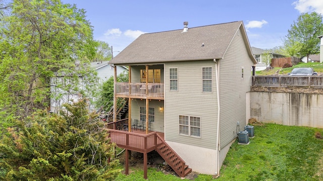 rear view of house featuring a yard and central AC