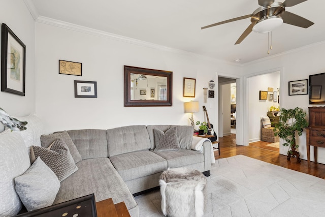 living room with crown molding, hardwood / wood-style floors, and ceiling fan