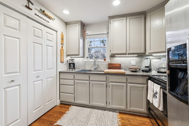 kitchen with gray cabinetry, sink, and appliances with stainless steel finishes