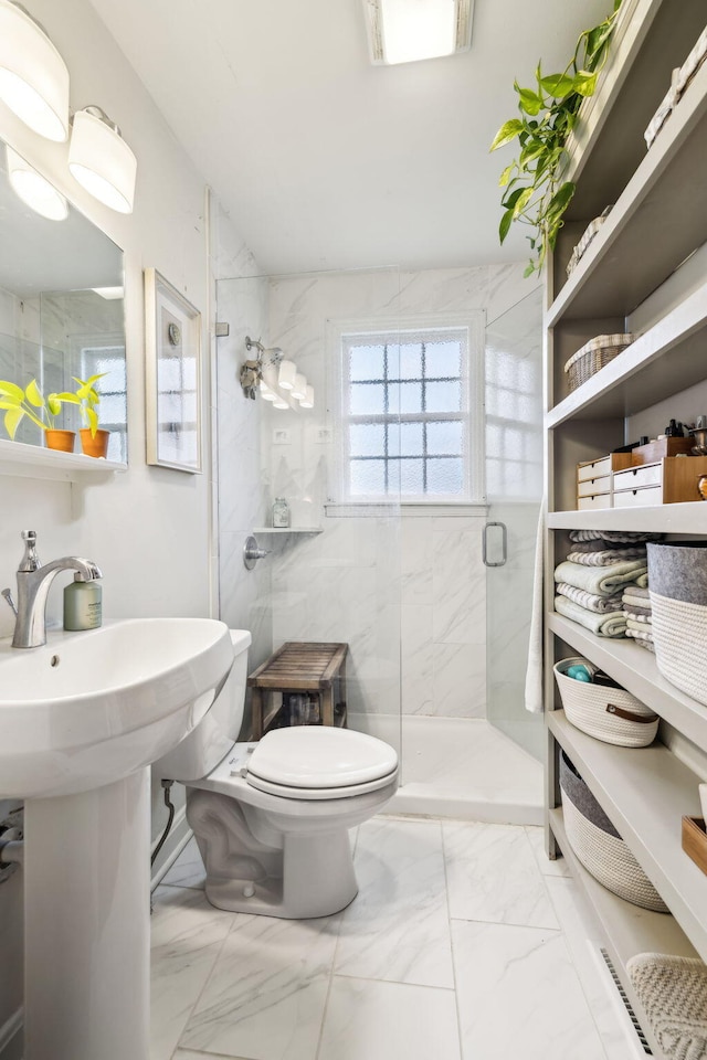 bathroom featuring toilet and walk in shower