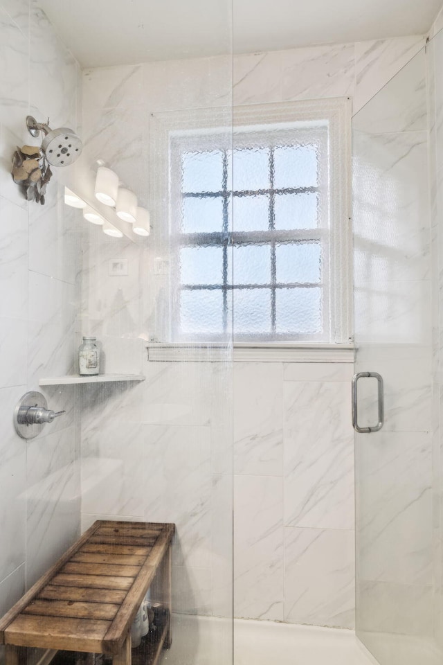 bathroom featuring a shower with shower door