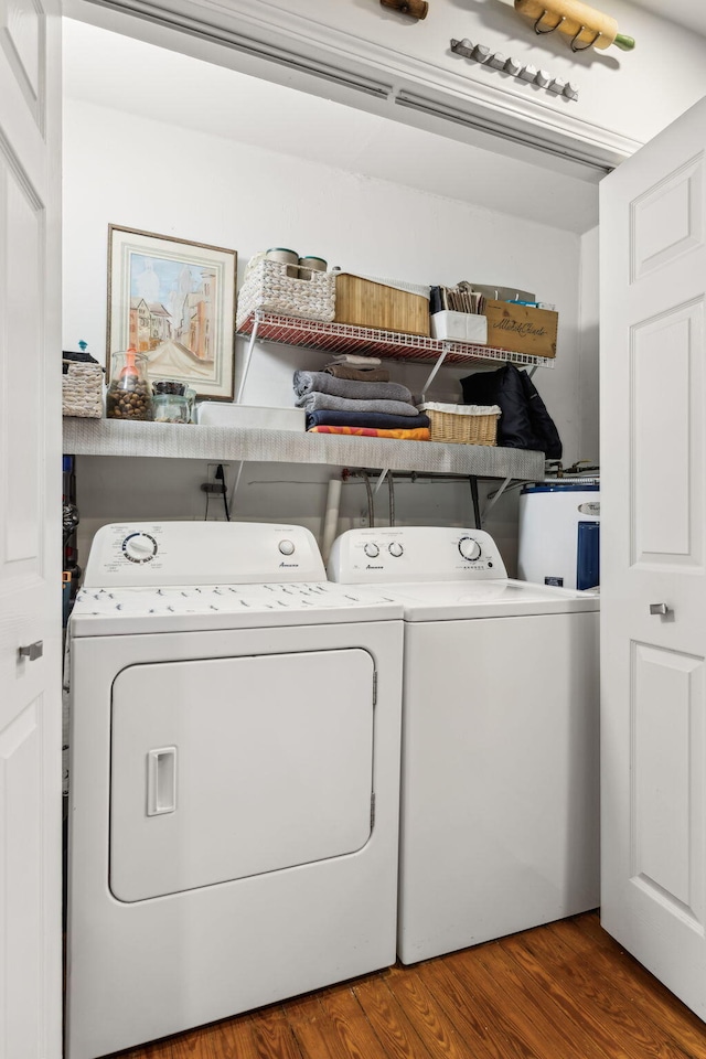 laundry room featuring separate washer and dryer, electric water heater, and hardwood / wood-style floors