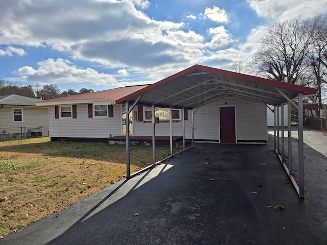 exterior space with a front yard and a carport