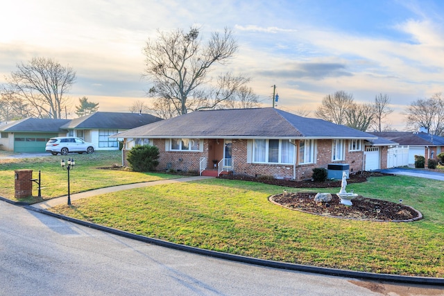 ranch-style home with a lawn