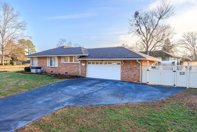 single story home with a lawn and a garage