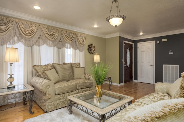 living room with hardwood / wood-style floors and crown molding