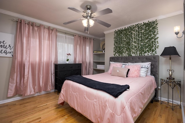 bedroom with light wood-type flooring, ceiling fan, and crown molding