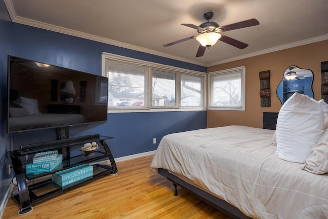 bedroom featuring hardwood / wood-style flooring, ceiling fan, and crown molding