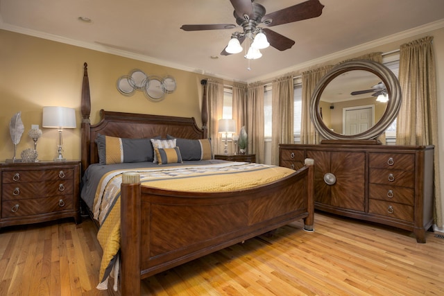 bedroom with light hardwood / wood-style flooring, ceiling fan, and crown molding