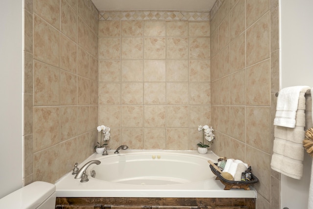 bathroom with a washtub, toilet, and tile walls