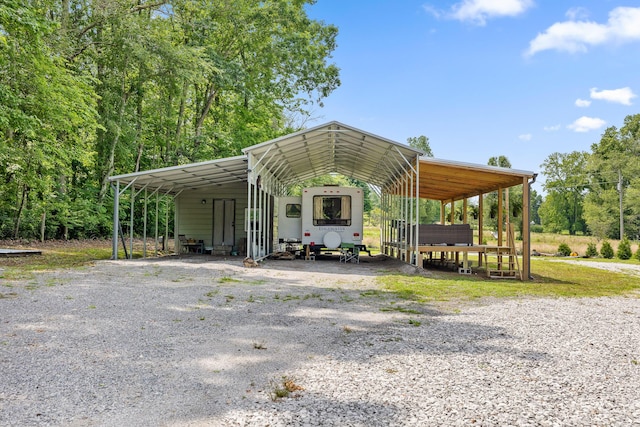 view of vehicle parking featuring a carport