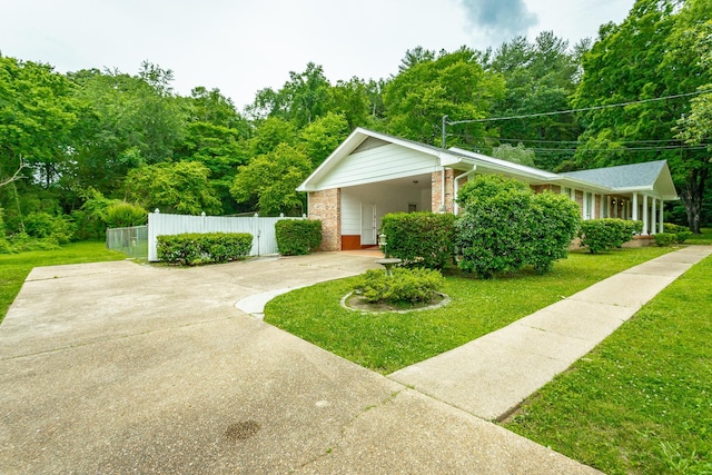 view of side of home featuring a yard and a carport