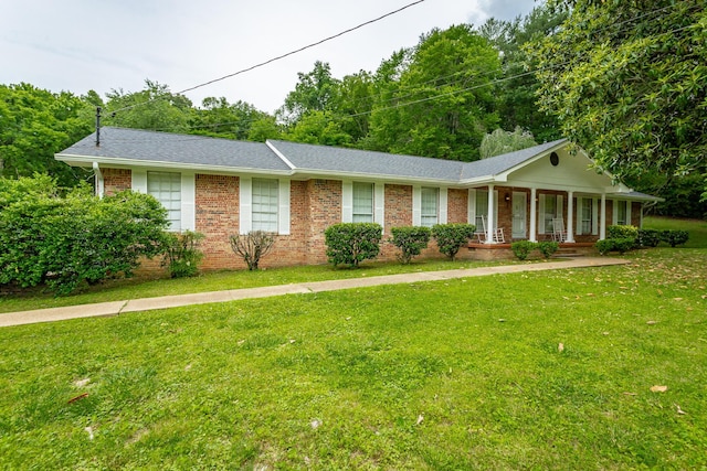 single story home with covered porch and a front yard