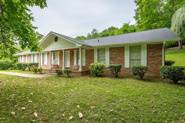 ranch-style home featuring a porch and a front yard