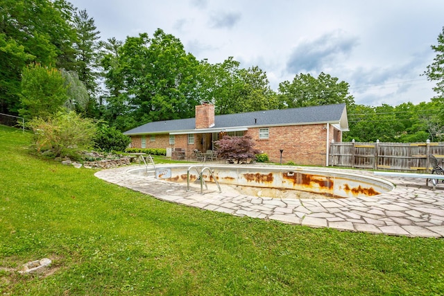 exterior space featuring a patio and an empty pool