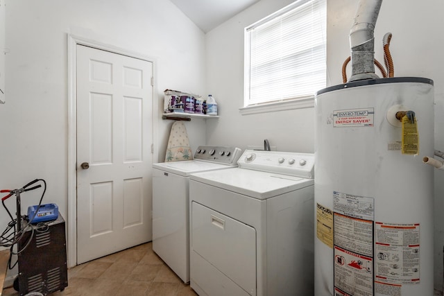 washroom featuring gas water heater and washing machine and dryer